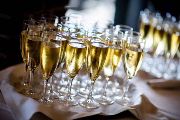 clear wine glasses with gold liquid on white cloth covered 2504941 1 scaled